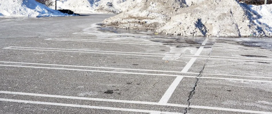 Cleared parking lot with snow piles in Ann Arbor, MI.