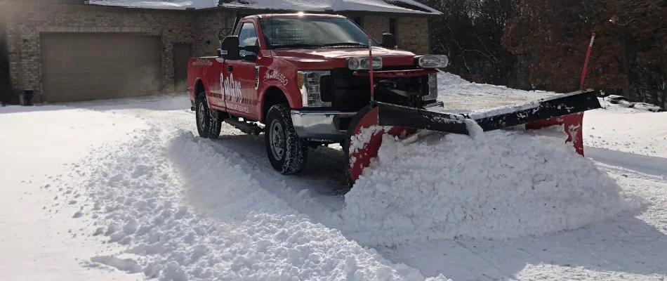 Plow truck in a snowy driveway in Ann Arbor, MI.